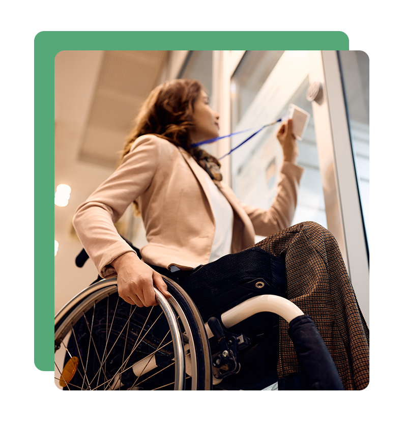 Woman in wheelchair using keycard access terminal